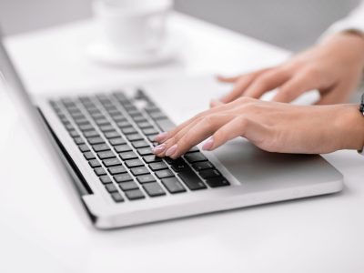 Freelance. Close up of woman using laptop, working at home, writing a blog, hands on keyboard. Copyspace